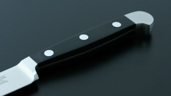 
                    The bread knife Alpha has a black, synthetic handle